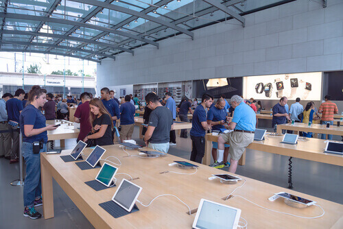 HOUSTON, Apple Store in Highland Village. Customer browsing iPhone, iPad, MacBook, staffs help in product introduction and technical support